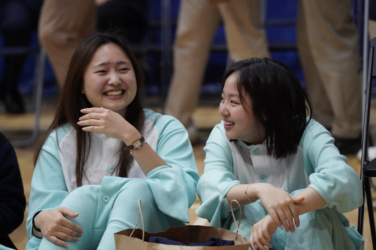 Drama club members sophomores Bonnie Kim and Lucy Kim enjoy some chill time in the audience after their performance. They cheer for their friends during the Illusion Dance Club performance. 